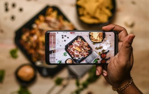 high-angle-view-person-holding-smart-phone-min